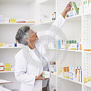 Mature pharmacist woman, shelf and boxes with thinking, packing stock and inventory inspection. Senior pharmacy manager