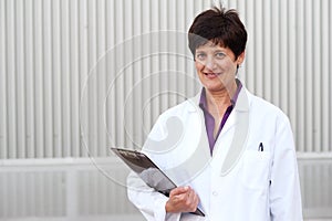 Mature professional woman dressed in labcoat photo