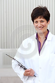 Mature professional woman dressed in labcoat photo