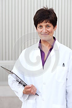 Mature professional woman dressed in labcoat photo