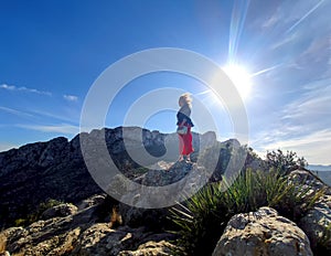 Mature redhead woman backlight with wind-blown hair on the mountain Cim Penya Roja, Els Poblets, Alicante, Spain photo