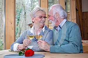 A mature romantic couple in a restaurant.