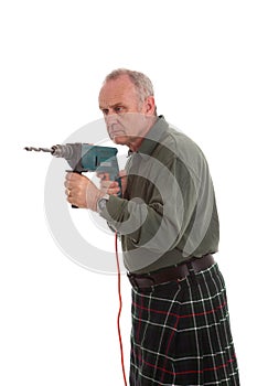 Mature scotsman using a power drill photo