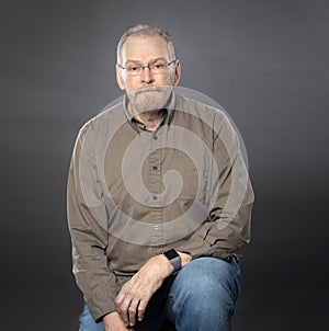 Mature senior man with gray hair glasses and beard