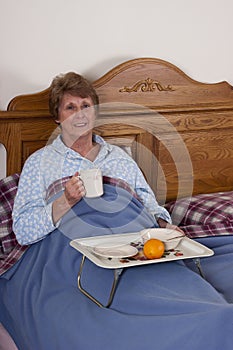 Mature Senior Woman Breakfast in Bed Smiling