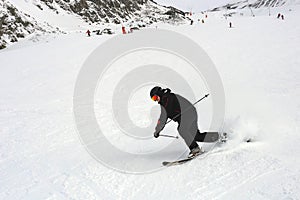 Mature skier fallen during downhill at ski resort in winter. Accident at ski slope due to unfasten ski binding. Extreme winter