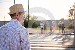 Mature spanish man waiting to cross street