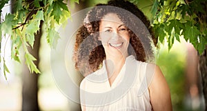 Mature Spanish Woman Smiling At The Camera. She is outside at the park. So happy