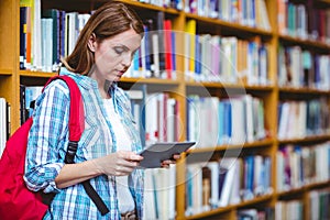 Mature student in the library using tablet