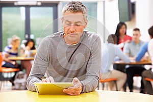 Mature Student Studying In Classroom With Digital Tablet