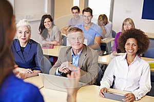 Mature Students In Further Education Class With Teacher photo