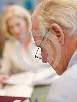 Mature students studying in library