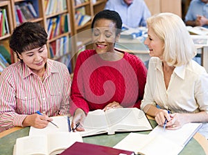 Mature students studying in library