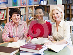 Mature students studying in library