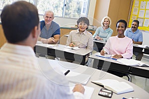 Mature students and their teacher in a classroom