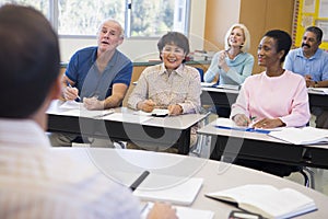 Mature students and their teacher in a classroom