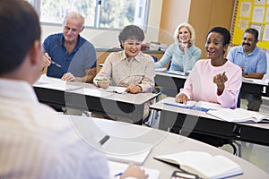 Mature students and their teacher in a classroom