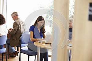 Mature Students Working In College Breakout Area