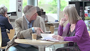 Mature Students Working In College Breakout Area