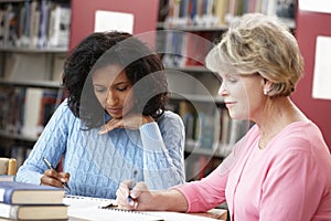 Mature students working in library