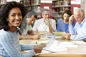 Mature students working in library