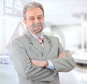 Mature successful businessman smiling and looking