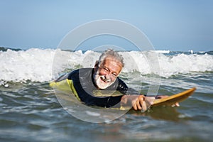 Mature surfer ready to catch a wave