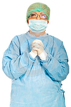 Mature surgeon woman praying