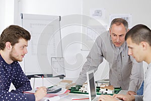 Mature teacher and students in computer lab classroom