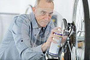 Mature technical expertise taking care bicycle shop