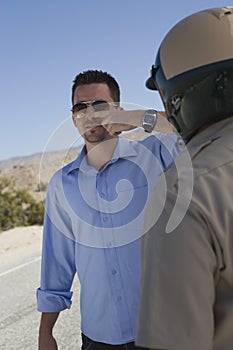 Mature Traffic Cop Taking Sobriety Test photo