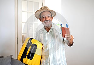 Mature Traveler Man Posing With Travel Suitcase And Tickets Indoors