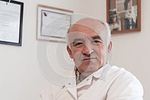 Mature veterinarian man or doctor in hospital clinic smiling happy and proud.