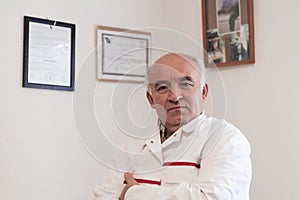 Mature veterinarian man or doctor in hospital clinic smiling happy and proud.