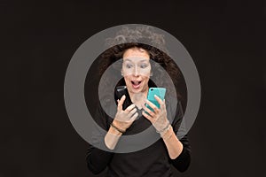 Mature woman with 2 cell phones Surprised open mouth