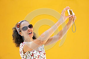 Mature woman 50s taking selfie Yellow background