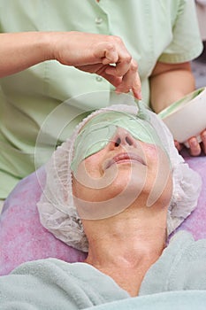 Mature woman, alginate face mask.