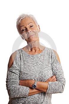 Mature woman with arms folded and head tilted