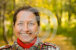 Mature woman in autumn park