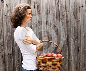 Mature woman with basket of apples