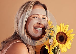 Mature woman and beauty portrait with flower bouquet and happy smile for natural skincare campaign. Wellness, cosmetics