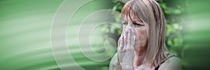 Mature woman blowing her nose; panoramic banner