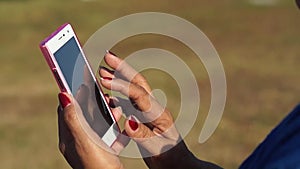 Mature woman browses internet with the use of mobile smartphone