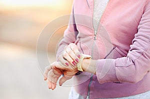 Mature woman cheking results after jog in the park