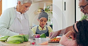 Mature, woman and child for teaching to cook in kitchen by cutting ingredients in preparation of vegan dinner. Mexican