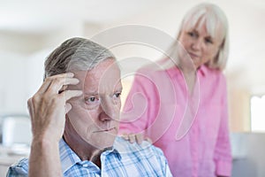 Mature Woman Comforting Man With Depression At Home