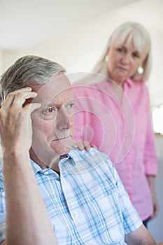 Mature Woman Comforting Man With Depression At Home