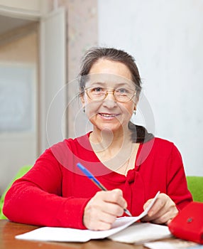 Mature woman counts family budget