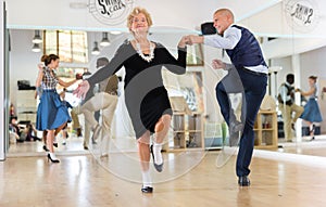 Mature woman dancing swing with young man