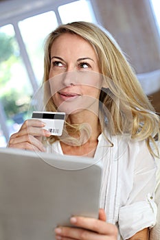 Mature woman doing online shopping with tablet